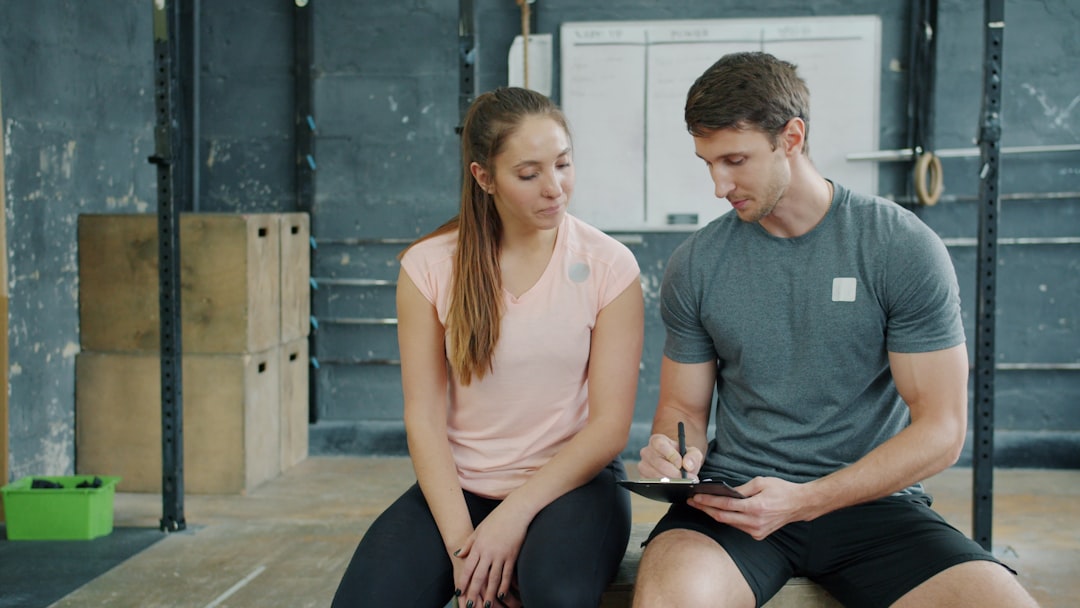 Un coach sportif guidant un client lors d'une séance d'entraînement en salle